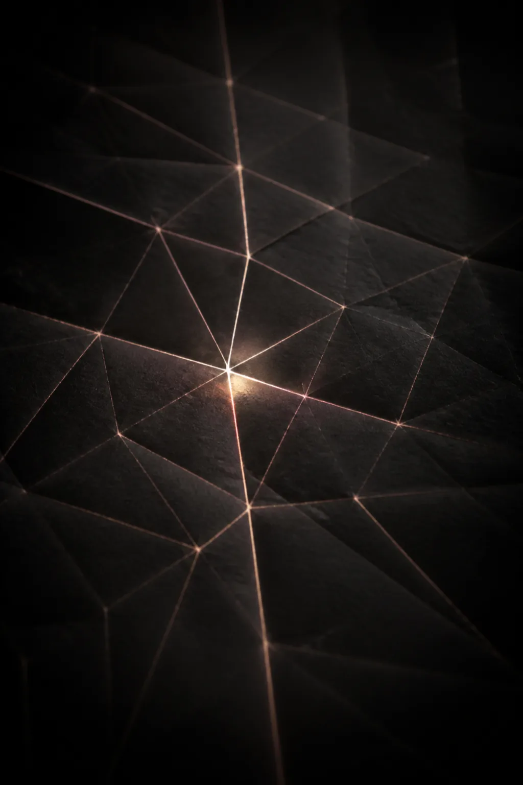 A vast sheet of deep charcoal-black paper fills the portrait frame, viewed as if backlit from …