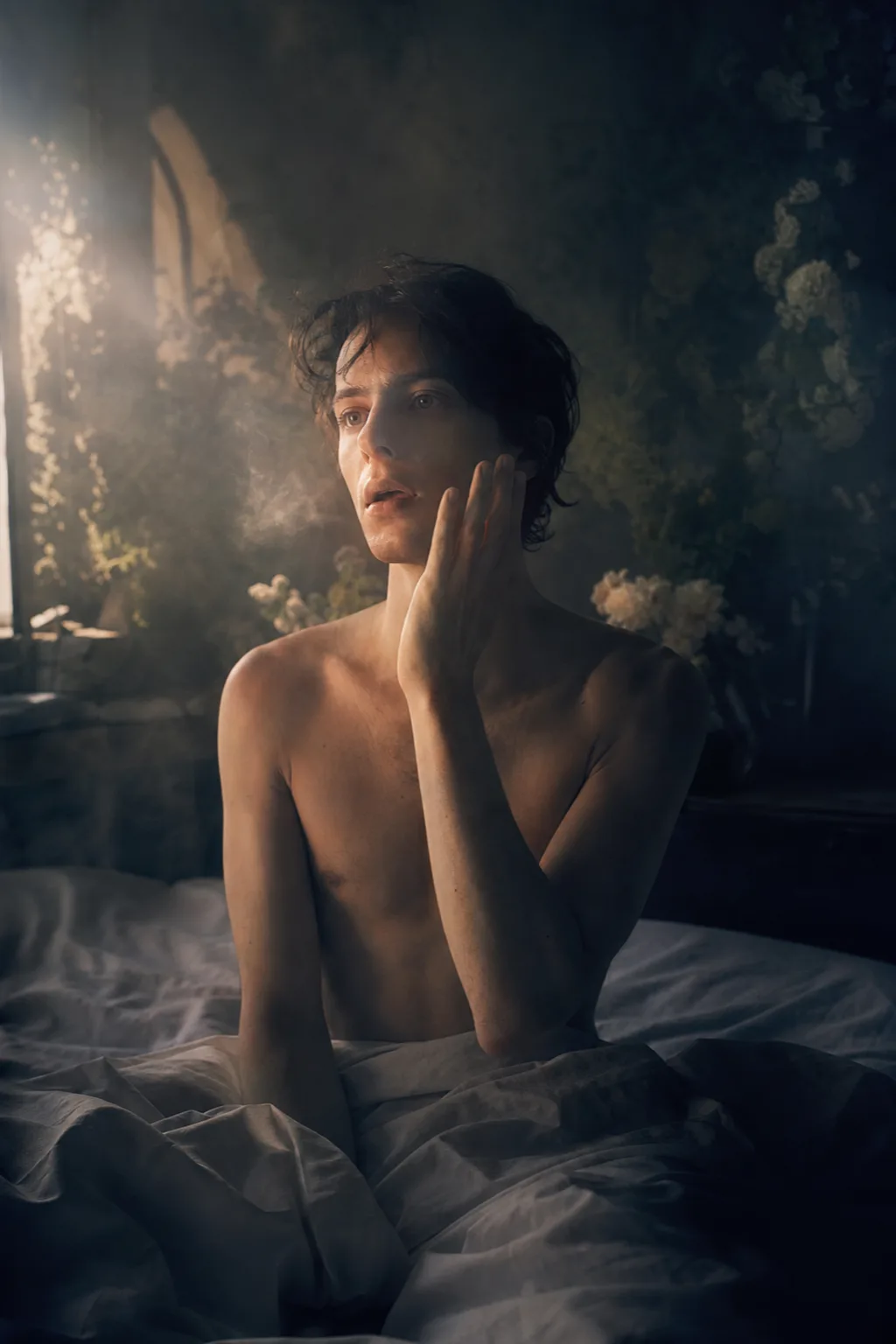 Portrait-format surreal fine-art photograph, a newly awakened androgynous adult figure sitting upright in a dim dawn …